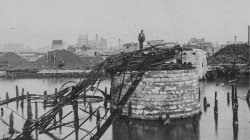 1871 Chicago. A man stands on the remains of the Van Buren Street Bridge
