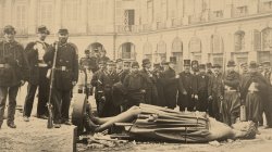 Communards and Gustave Courbet pose with the statue of Napoléon I from the toppled Vendôme column